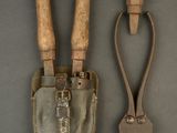 pair of old garden tools on a gray surface with a wooden handle