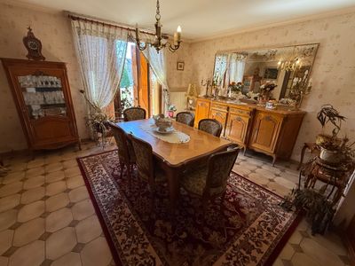 a dining room with a table and chairs and a chandelier