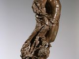 bronze statue of a woman holding a child on a marble pedestal