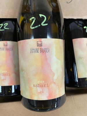 three bottles of wine sitting on a table next to each other