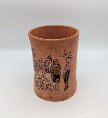 an image of a brown cup with a drawing of people on it