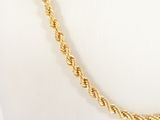 an image of a gold rope necklace on a mannequin mannequin