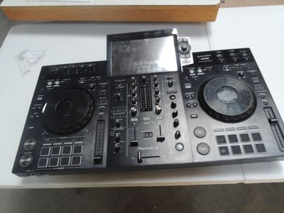 a dj controller sitting on a table next to a cd player