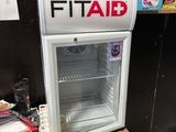 a refrigerator with a sign that says fit aid on it