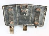 an old leather case sitting on top of a white surface