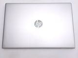 hp laptop computer sitting on a white surface with a logo on the screen