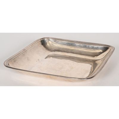 a silver plate with a handle on it