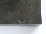 a close up of a metal object on a white surface