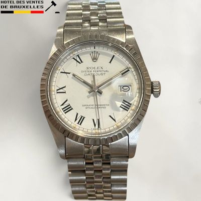 an image of a wrist watch with roman numerals on a bracelet