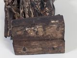 a statue of a man sitting on top of a wooden box