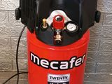 an air compressor sitting on top of a tiled floor next to a wall