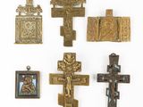 several crosses are displayed on a white surface with a cross in the middle