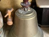 a bell sitting on a counter next to a pot