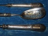 three spoons and two spoons sitting in a blue box