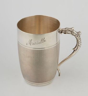 a silver cup with a handle and a handle on it