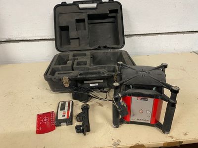 a small case with a remote control and other items on a table