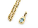 a gold chain with a blue topaz stone pendant and a gold chain with a blue topaz stone pendant