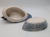 a bowl and a bowl with a fish on it
