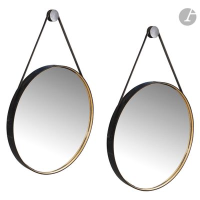 a pair of black and gold mirrors hanging on a wall