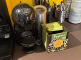 a box of tea sitting on a counter next to a coffee maker