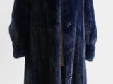 a photo of a blue fur coat on a mannequin stand