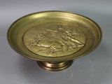 brass plate with a horse and rider on it on a pedestal