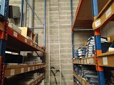 a ladder that is going up to the ceiling in a warehouse