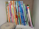 a lot of books on a shelf next to a cd