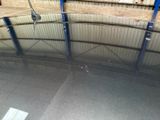 a reflection of a person on a skateboard in a parking garage