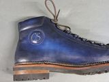 a pair of blue boots that are on the floor