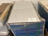 many boxes of mattresses stacked on pallets in a room