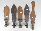 five wooden knives are lined up on a white surface