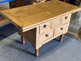 a wooden table with two drawers on top of it