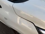 a close up of a white car with the hood down