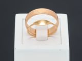 an image of a gold wedding ring on a white box