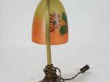 an image of a lamp with a yellow shade and a flower on it