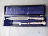 a silverware set in a blue box with a knife and fork