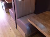 a booth with a table and two chairs in front of it
