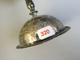 a silver bell with a price tag on it
