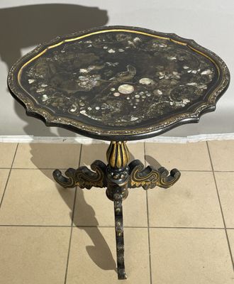 a black and gold table with shells on it