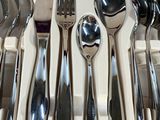 a tray with silverware in it and a knife, fork, spoon, and spoon rest