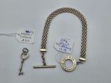 a key, a keychain, and a tag on a table