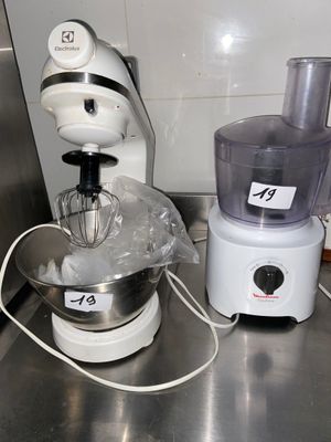 a blender and a mixer sitting on a kitchen counter
