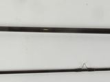 a pair of old fishing rods on a white surface