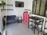 two pictures of a living room with a couch and a table