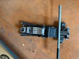 a broken cell phone sitting on the floor next to a pole