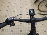 a close up of a bicycle handlebar with a cell phone on it