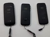 three cell phones that are connected to a lanyard