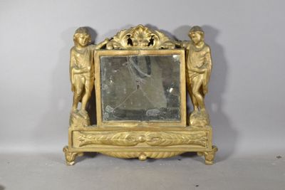 a small gold clock with a mirror on top of it