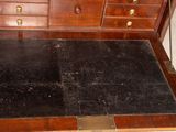 a wooden desk with a black rug on top of it